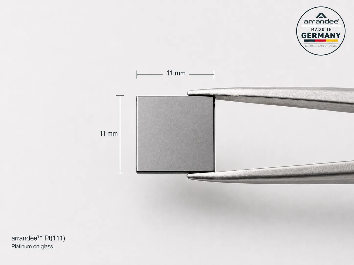 11 x 11 mm arrandee platinum substrate held with laboratory tweezers